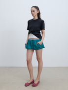 RARELY ALIKE Twisted Hem Cotton Silk Blend Tee in Black - On Model