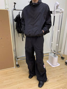 NeverSeez Accordion Pocket Wide Leg Cargo Pants in Black - On Male Model