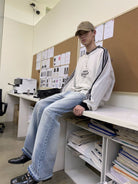 NeverSeez Distressed Washed Micro Flare Jeans in Blue - On Model