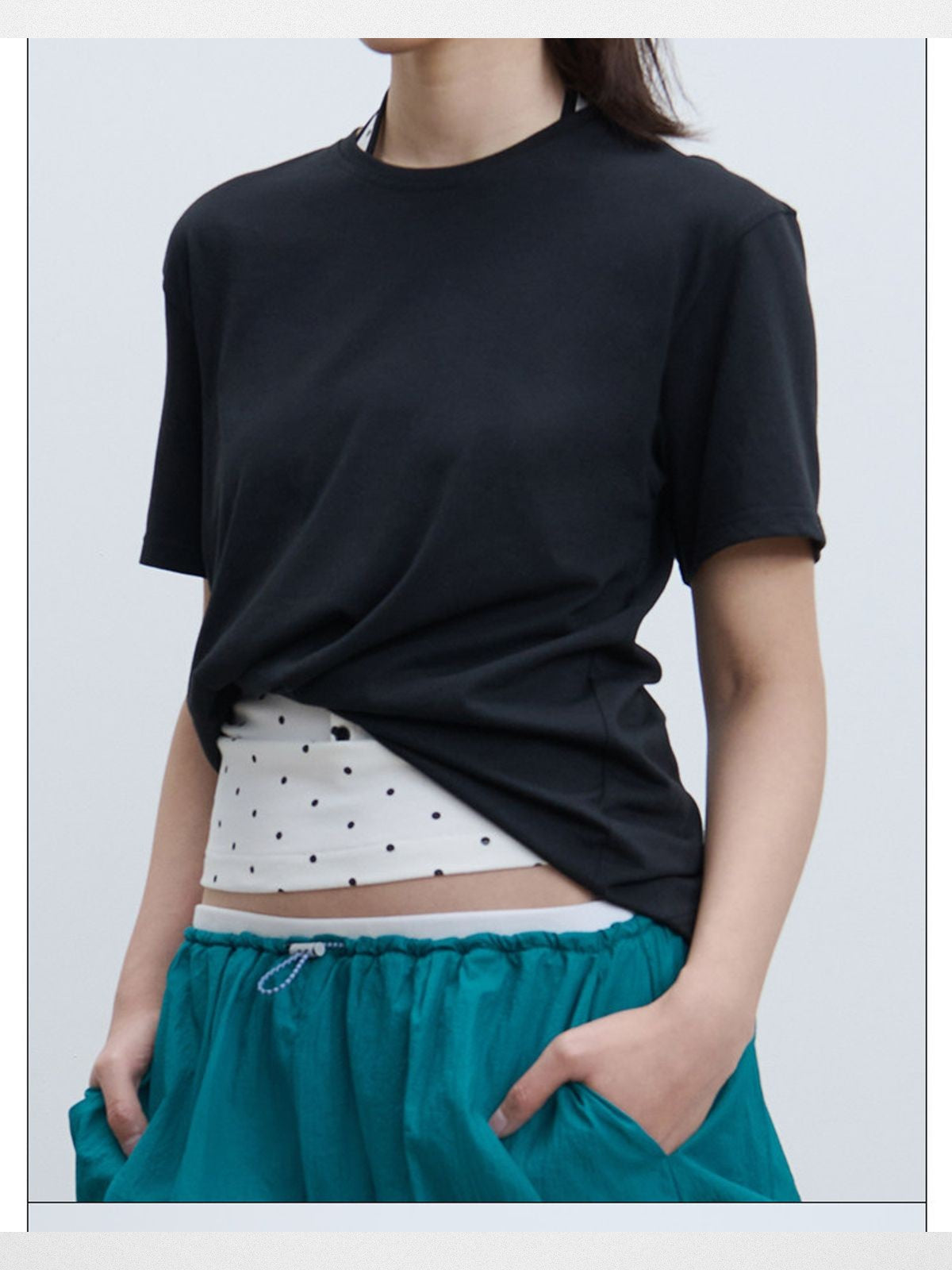 RARELY ALIKE Twisted Hem Cotton Silk Blend Tee in Black - On Model