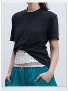 RARELY ALIKE Twisted Hem Cotton Silk Blend Tee in Black - On Model