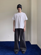 NeverSeez Embossed Script Cotton T Shirt in White - On Male Model